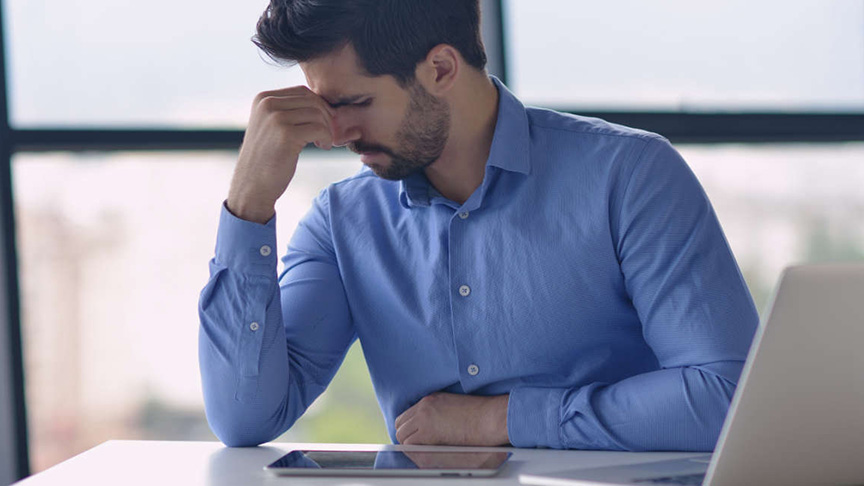 Man holding head with hand
